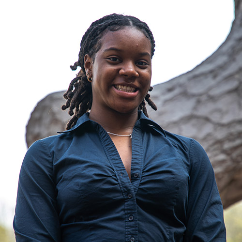 Image of Rebecca Oji, wearing a blue-green blouse
