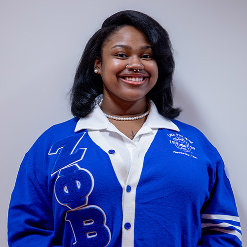 Image of Zokeria Monro, wearing a Zeta Phi Beta cardigan