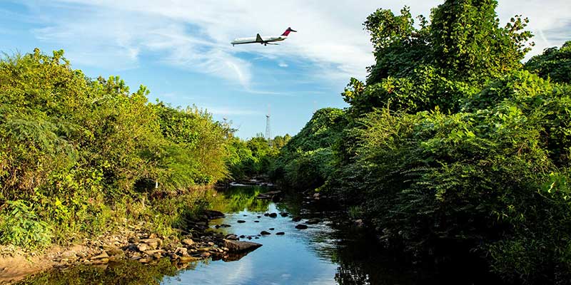 Plane flying over river