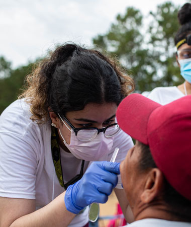 Healthcare worker examines patient