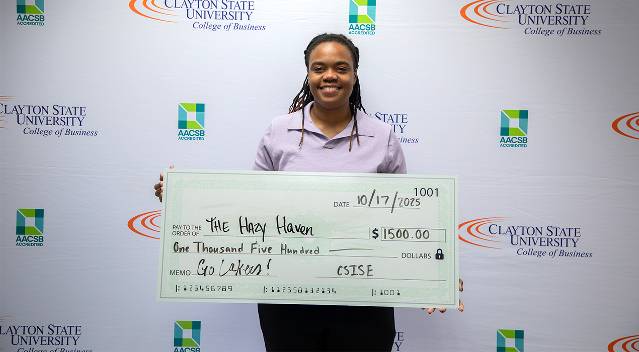 student-holds-winning-prize-check