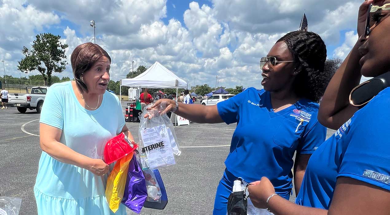 Lakers from the university's Dept. of Dental Hygiene share free supplies with a local resident.